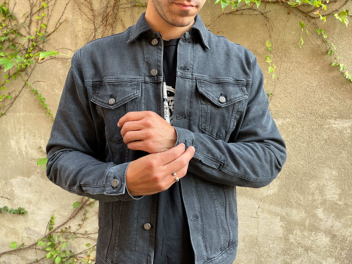 a young very beautiful woman in a black T-shirt denim jacket and pants  turning to